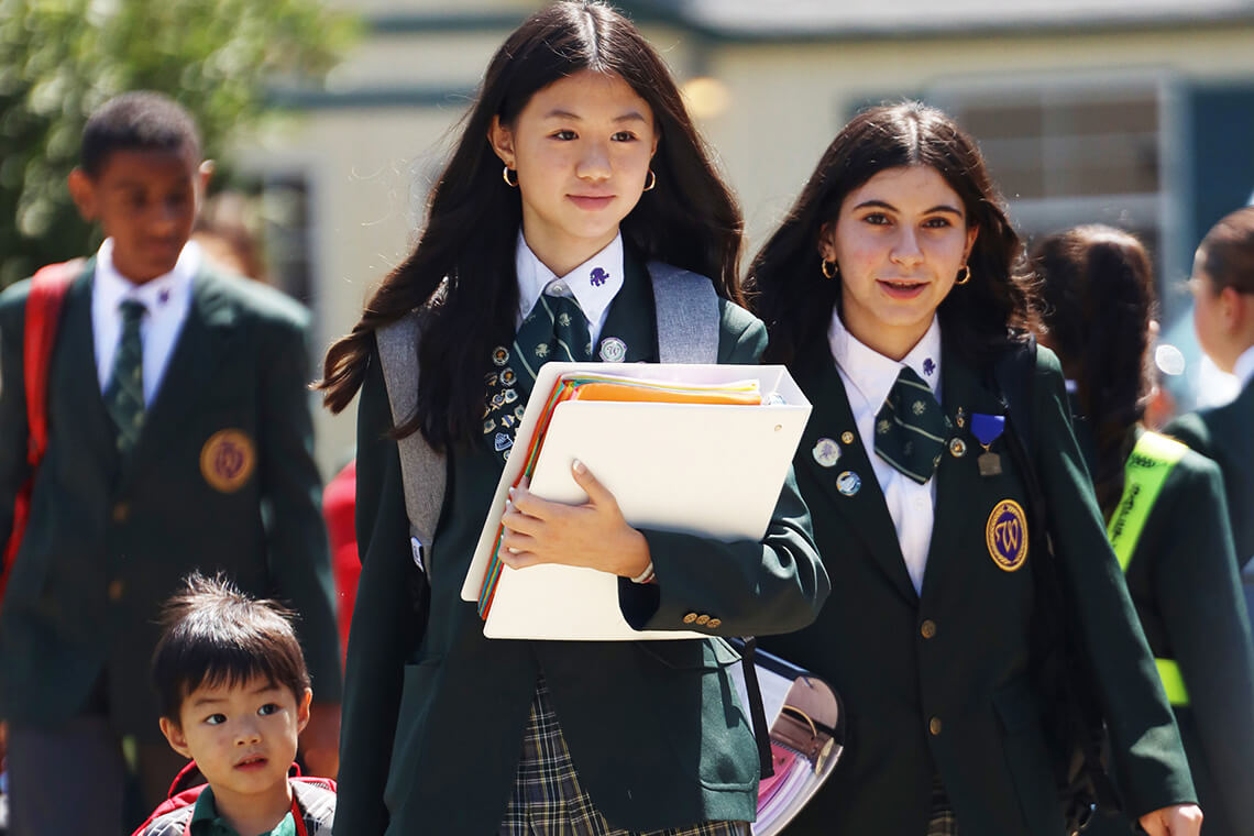 home-westminster-journey Students in school uniforms walking together on campus.