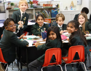 students sitting at a table in a classroom