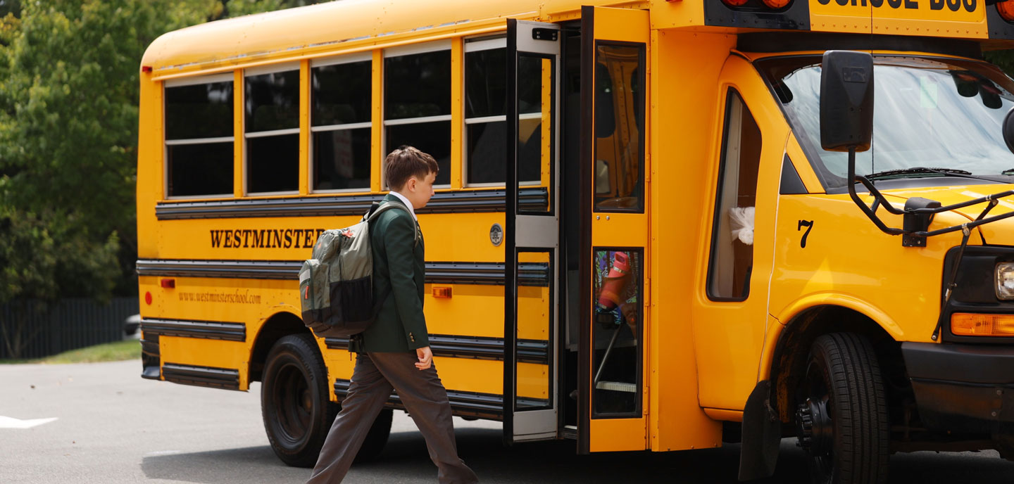 student getting on a bus