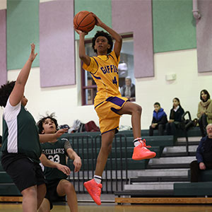 Basketball player shooting a basketball mid air jump shot