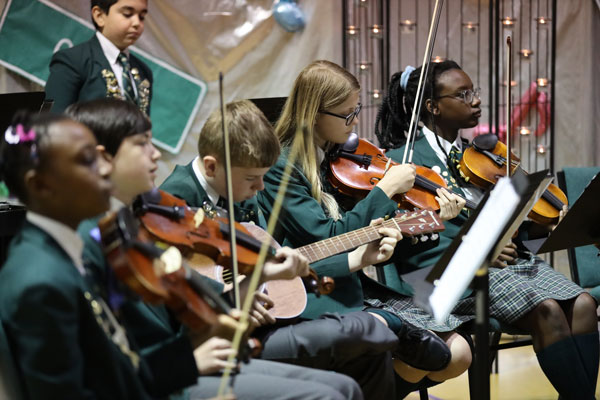 students playing violin in orchestra