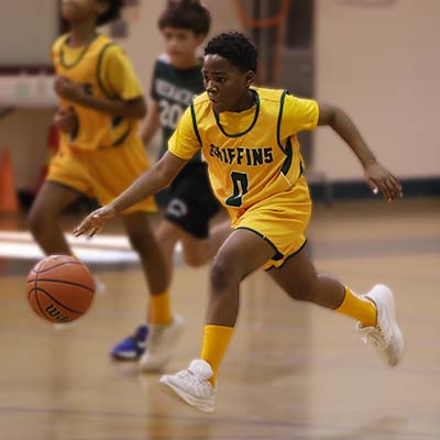 Boy dribbling and running with basketball