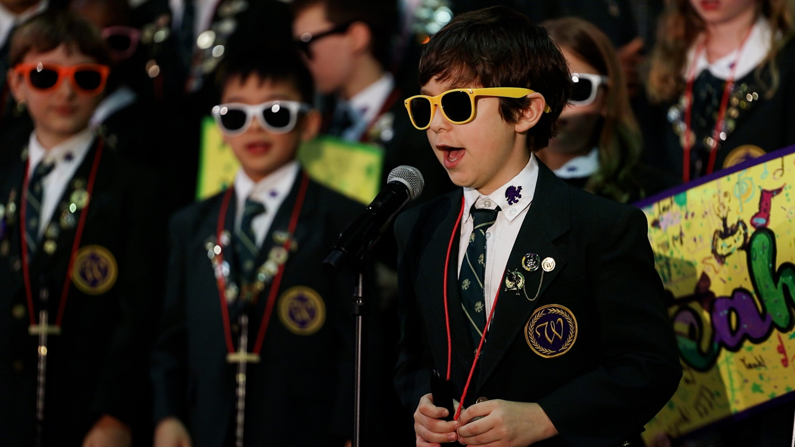 Music Program student wearing sunglasses singing into microphone at Westminster School in Annandale, VA