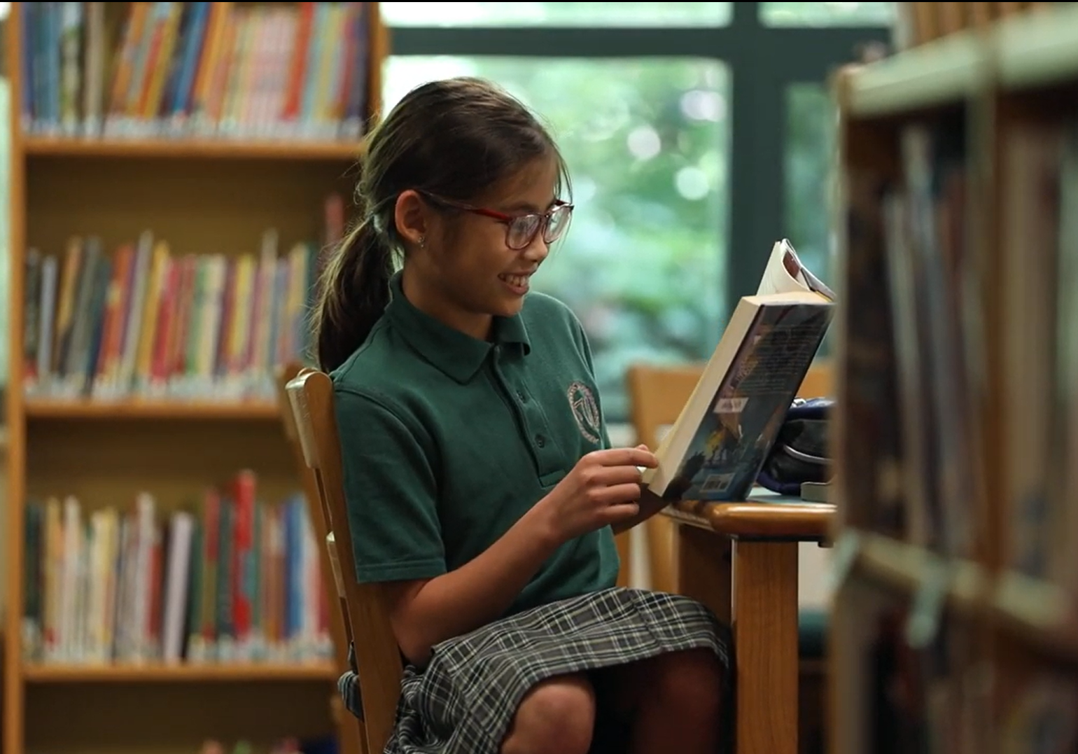 schrier Student reading a book in the school library.
